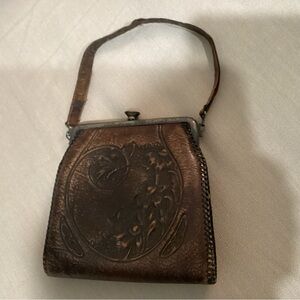 ANTIQUE  Handtooled leather handbag dating from the 1910s-1930s. A